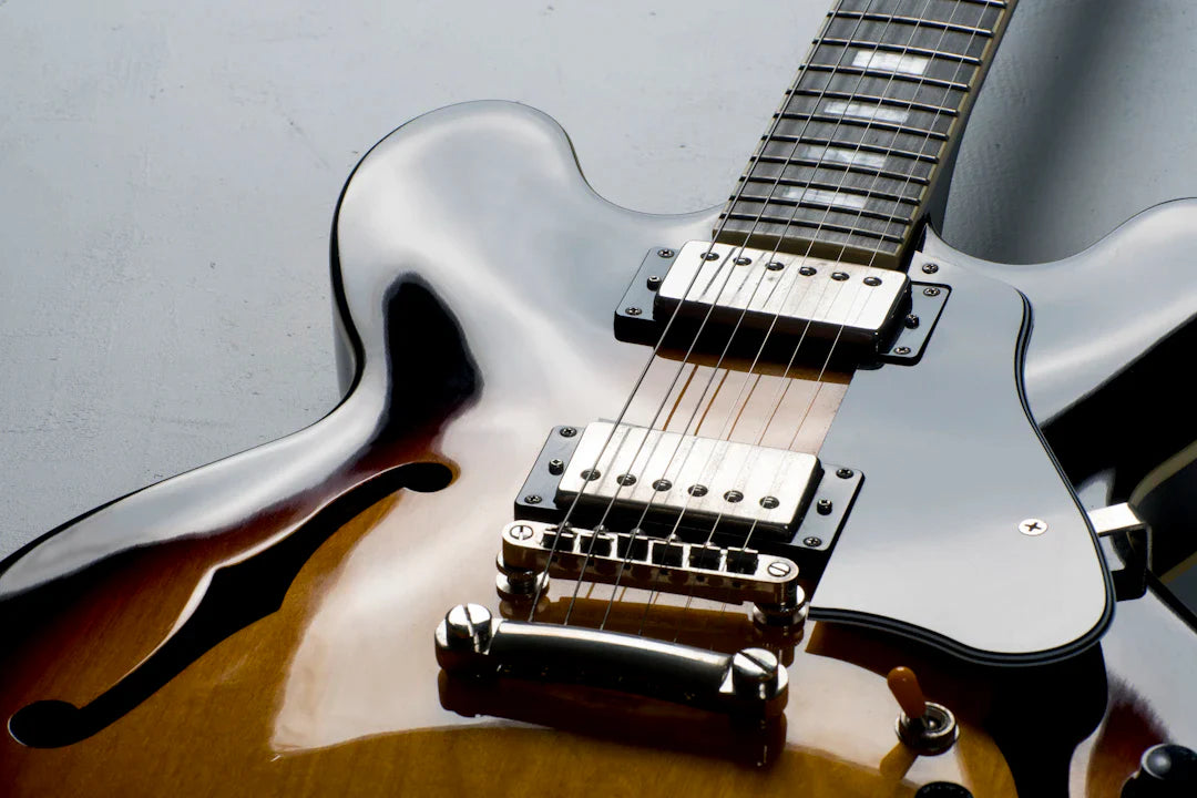 Close-up of a high-end semi-hollow body electric guitar with sunburst finish and dual humbuckers