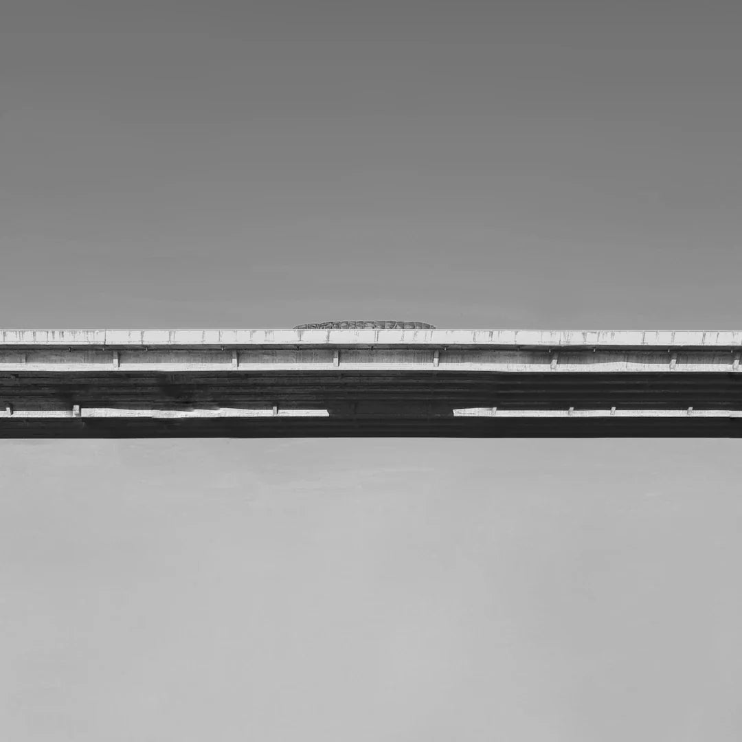 Monochrome photo of a highway overpass with a clear sky backdrop
